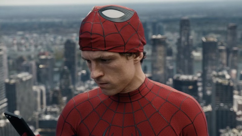 Spider-Man (Tom Holland) with his mask lifted up in 