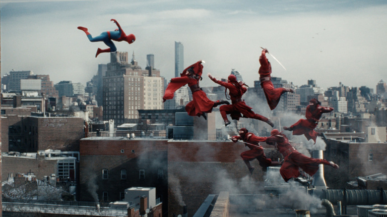 Tom Holland as Peter Parker wearing his Spider-Man outfit and fighting several ninjas dressed in red in Spider-Man: Brand New Day