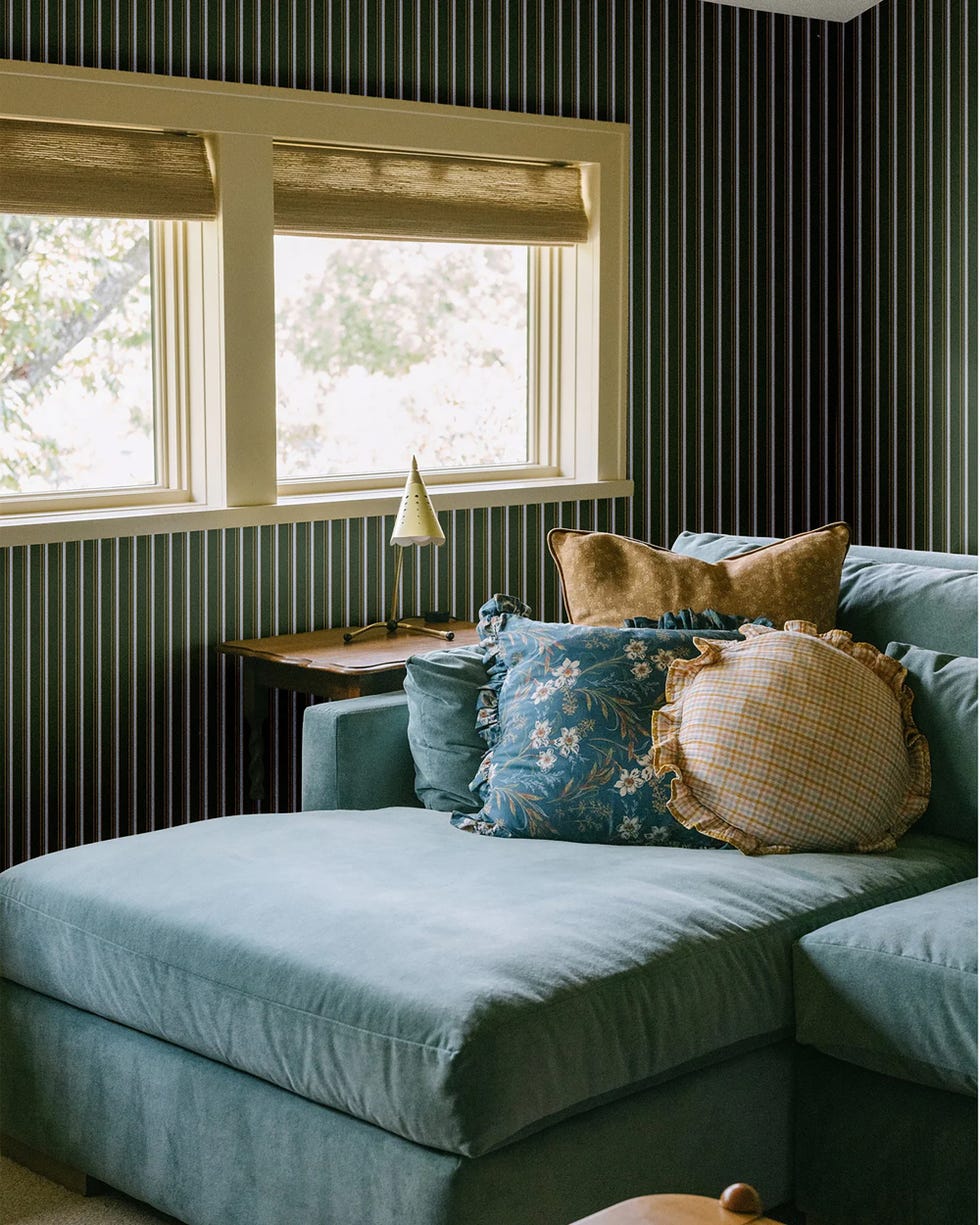 cozy living room corner with a section of a teal sofa adorned with decorative pillows