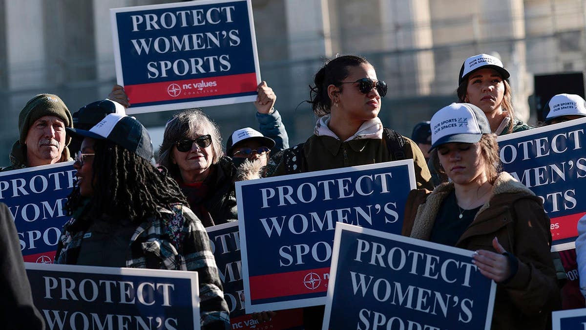 Protesters against transgender athletes competing in women's sports gather outside the Supreme Court in Washington, D.C.