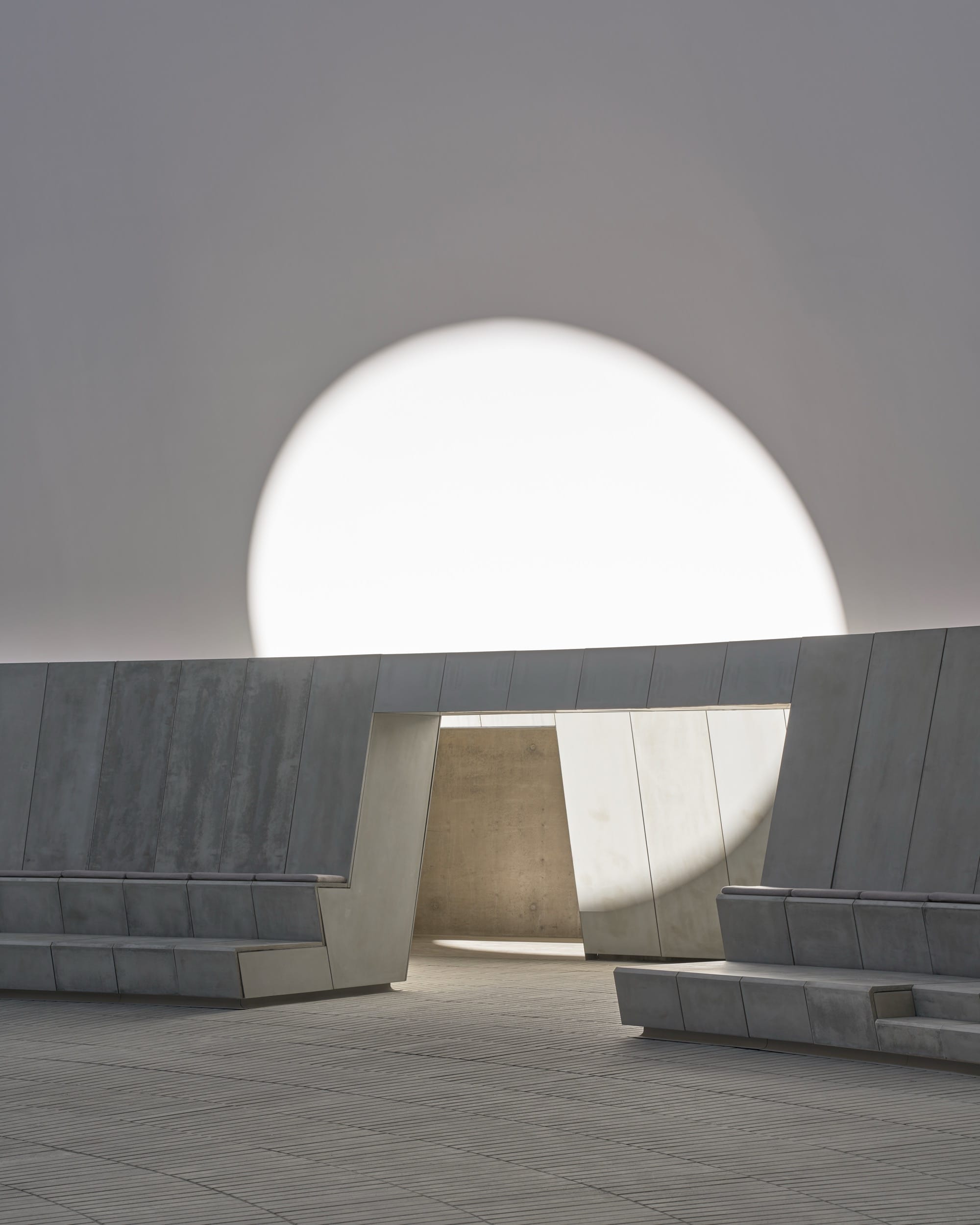 a large-scale light exhibition by James Turrell featuring a bench with a sphere of light
