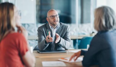 Two clients sitting in a conversation with a financial advisor.