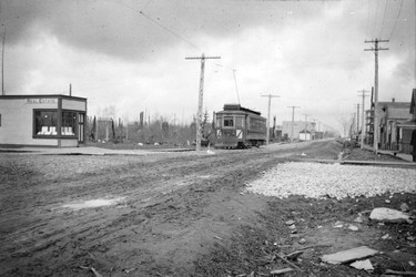 1911: Fraser Street between 50th and 51st. Real estate office and streetcar are visible.