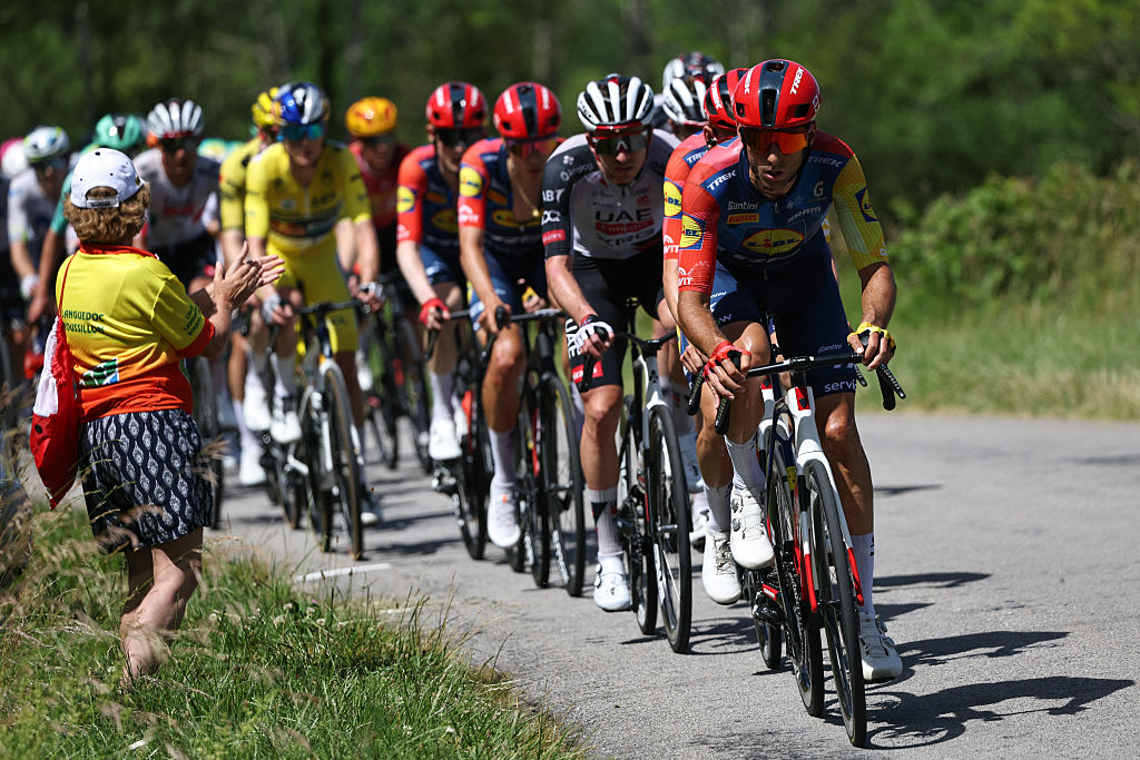 Lidl-Trek's Spanish rider Carlos Verona leads the pack of riders (peloton) during the 7th stage of the Tour Auvergne-Rhone-Alpes cycling race (formerly known as the Criterium du Dauphine), 133,6km between La Bridoire and Grand Colombier in the French Alps on June 13, 2026. (Photo by Anne-Christine POUJOULAT / AFP)