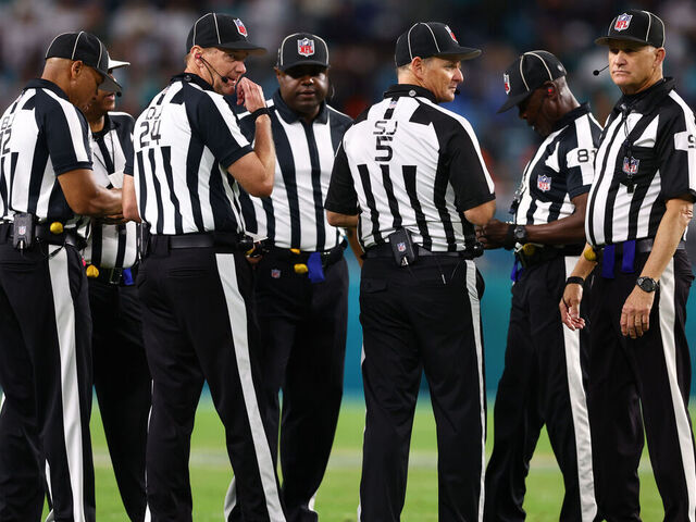 MIAMI GARDENS, FLORIDA - DECEMBER 11: NFL referees huddle during the fourth quarter of a game between the Tennessee Titans and Miami Dolphins at Hard Rock Stadium on December 11, 2023 in Miami Gardens, Florida.