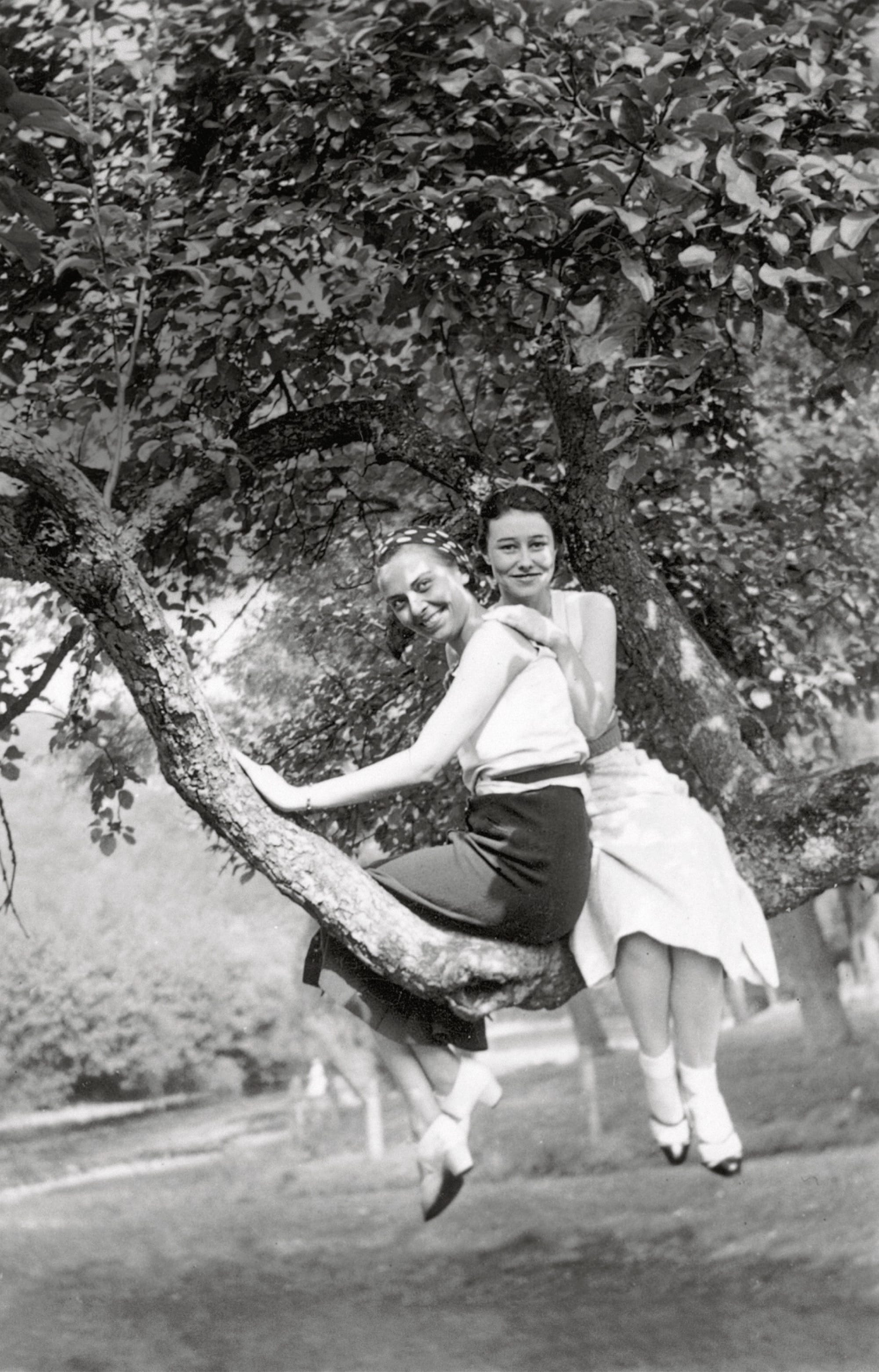 a black-and-white snapshot of two women in a tree