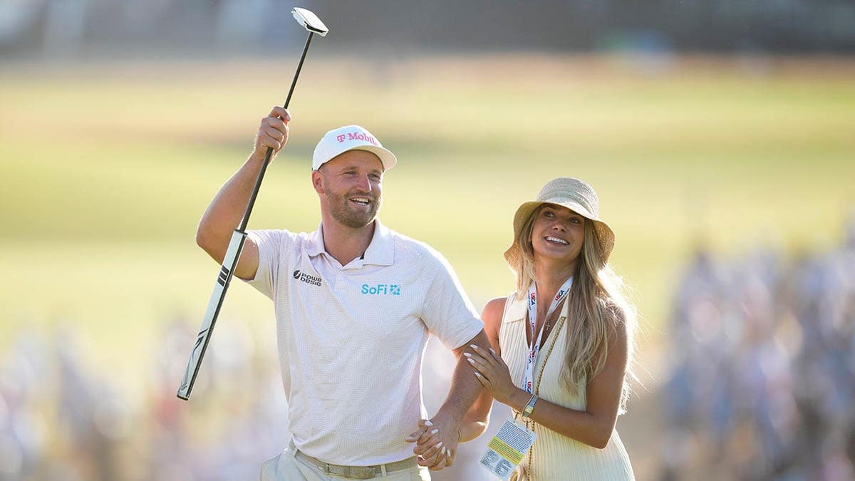Wyndham Clark standing with his girlfriend Emily Tanner at Shinnecock Hills Golf Club.