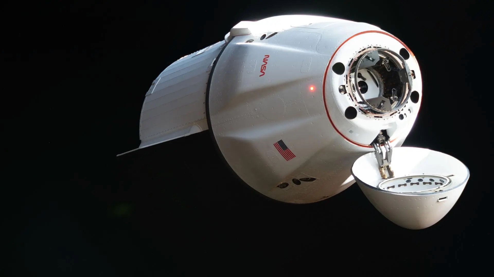close-up photo of a white cargo capsule in deep space
