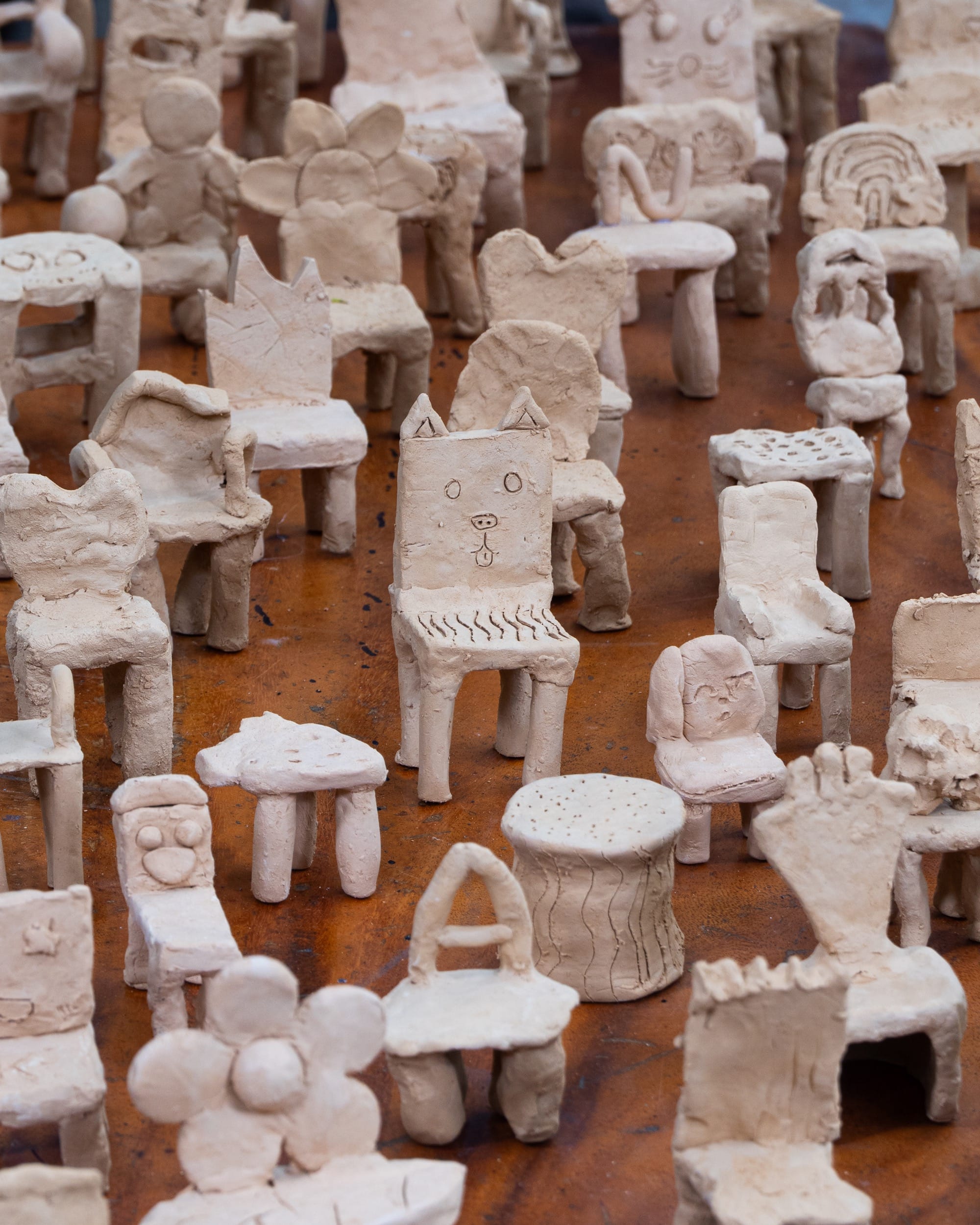 a large number of clay prototypes of whimsical chairs