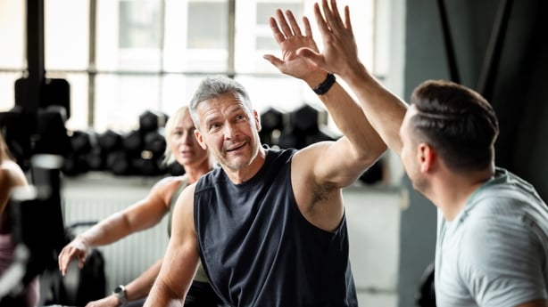 male athletes high fiving in the gym