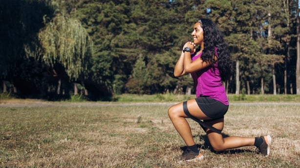woman exercising with a resistance band on the legs