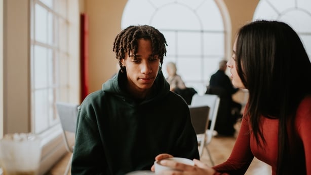 anxious teen speaking with woman