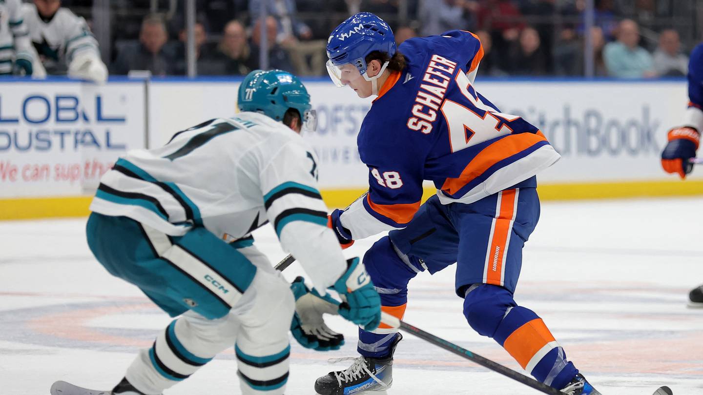 Oct 21, 2025; Elmont, New York, USA; New York Islanders defenseman Matthew Schaefer (48) skates with the puck against San Jose Sharks center Macklin Celebrini (71) during the second period at UBS Arena. Mandatory Credit: Brad Penner-Imagn Images