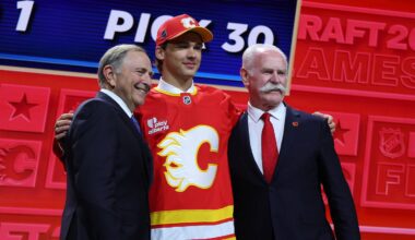 Jun 26, 2026; Buffalo, New York, USA; Jack Hextall reacts beside NHL commissioner Gary Bettman and former NHL player Lanny McDonald after being selected with the thirtieth pick in the first round of the 2026 NHL Draft by the Calgary Flames at KeyBank Center. Mandatory Credit: Timothy T. Ludwig-Imagn Images