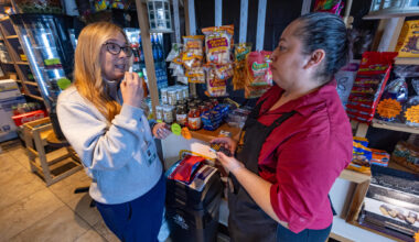Registered nurse Denise Hartley, co-founder of Atlantic Hill Nursing and Wellness, demonstrates to cafe owner Diana Cardona how to administer naloxone. (Jesse Costa/WBUR)