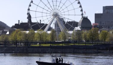 Police boat in the water with Montreal's Old Port in the background.