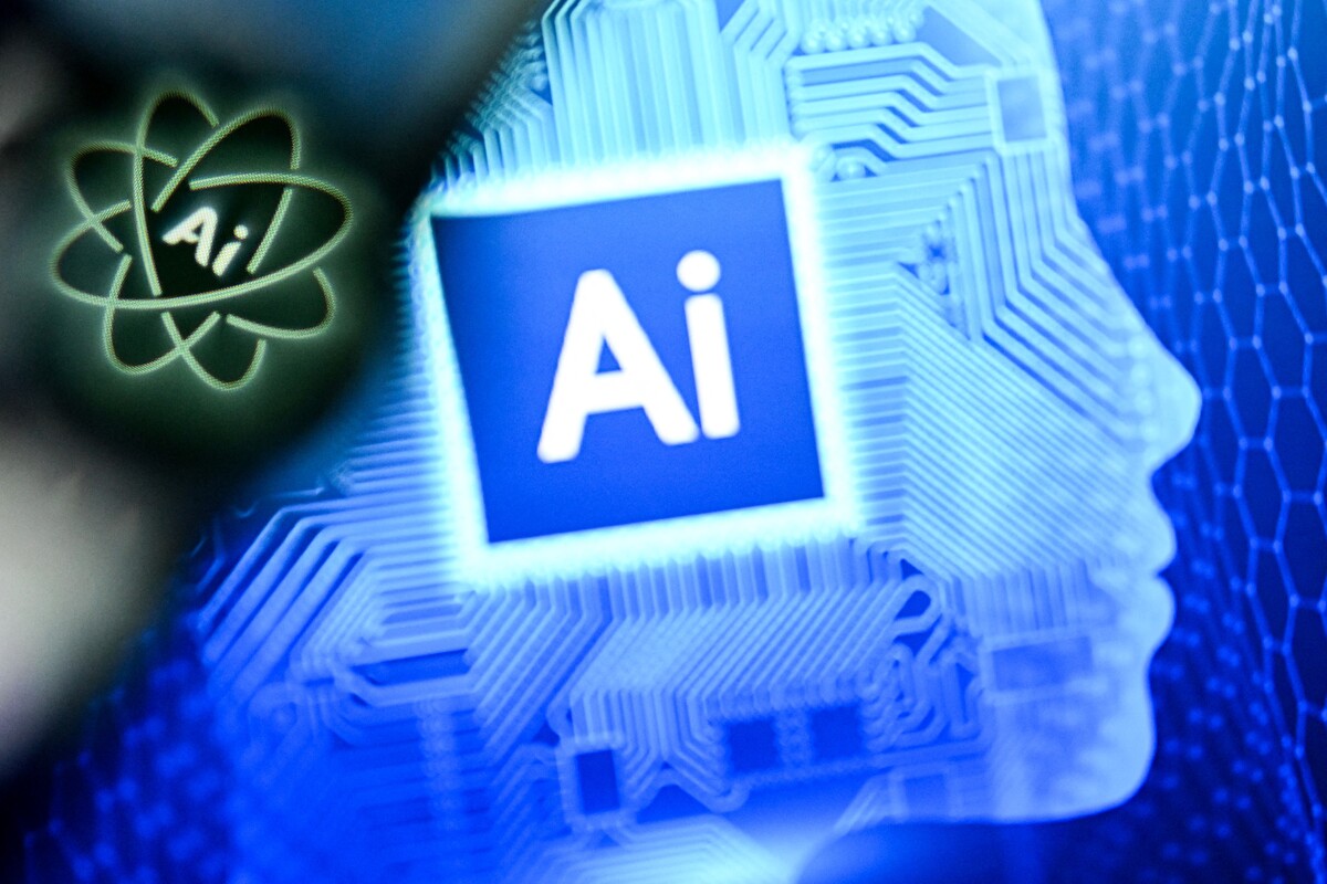 A photo taken on Jan. 2, 2025, shows the letters AI for Artificial Intelligence on a laptop screen next to the logo of the Chat AI application on a smartphone screen.