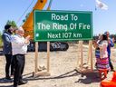 Transportation Minister Prabmeet Sarkaria, left, Premier Doug Ford and Webequie Chief Lorraine Whitehead unveil a road sign during a ground-breaking ceremony held on June 25, 2026.