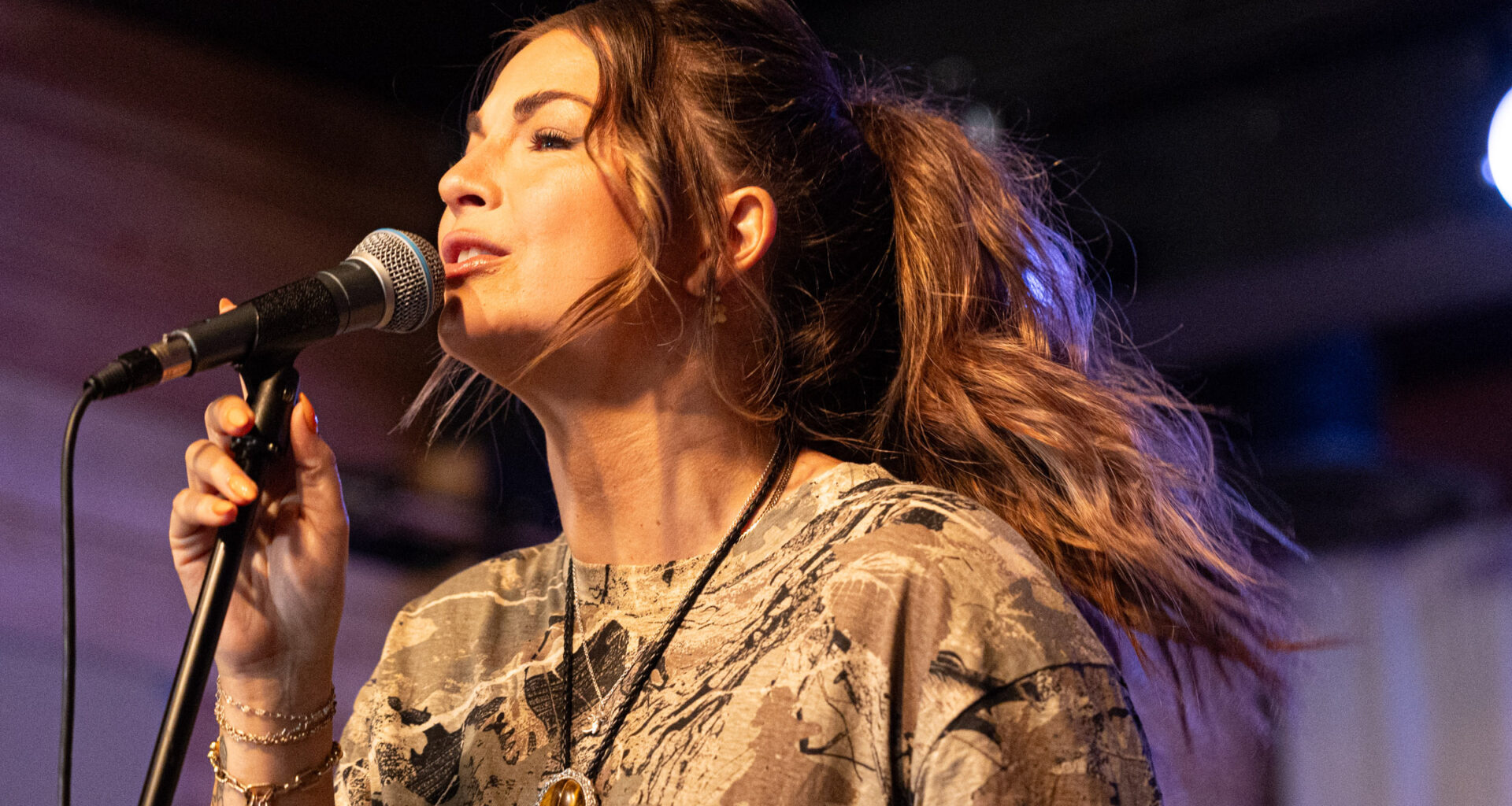 Jess Moskaluke performs on a stage.