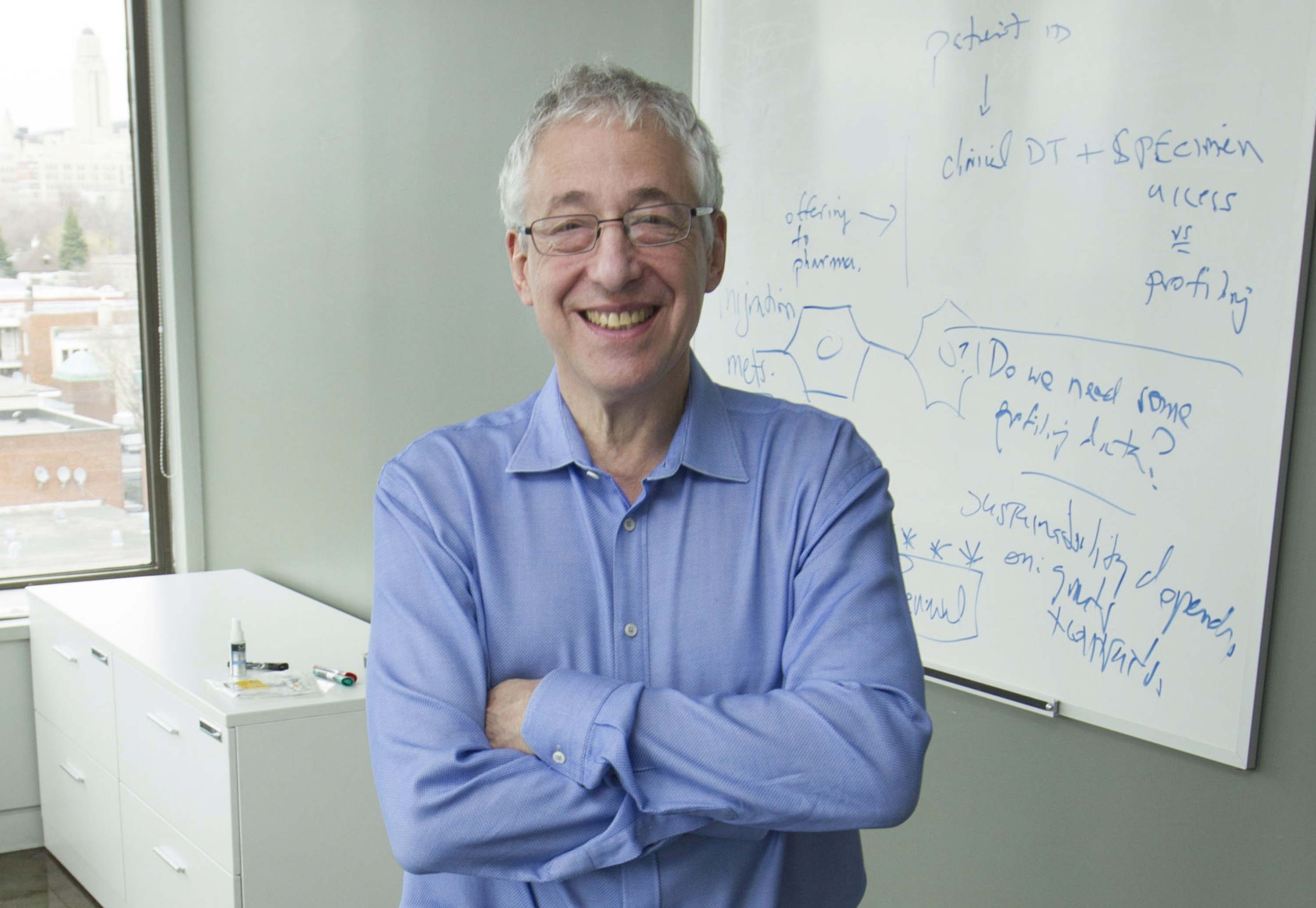 Dr. Gerald Batist in front of a whiteboard.