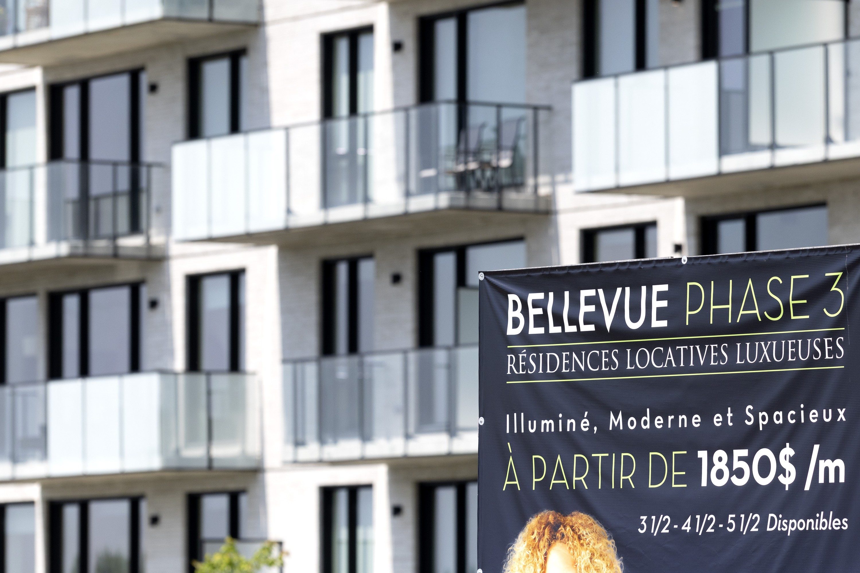 A for rent sign on a new apartment complex lists prices as starting at $1,850 per month.