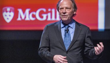 Man stands on McGill stage delivering a lecture.