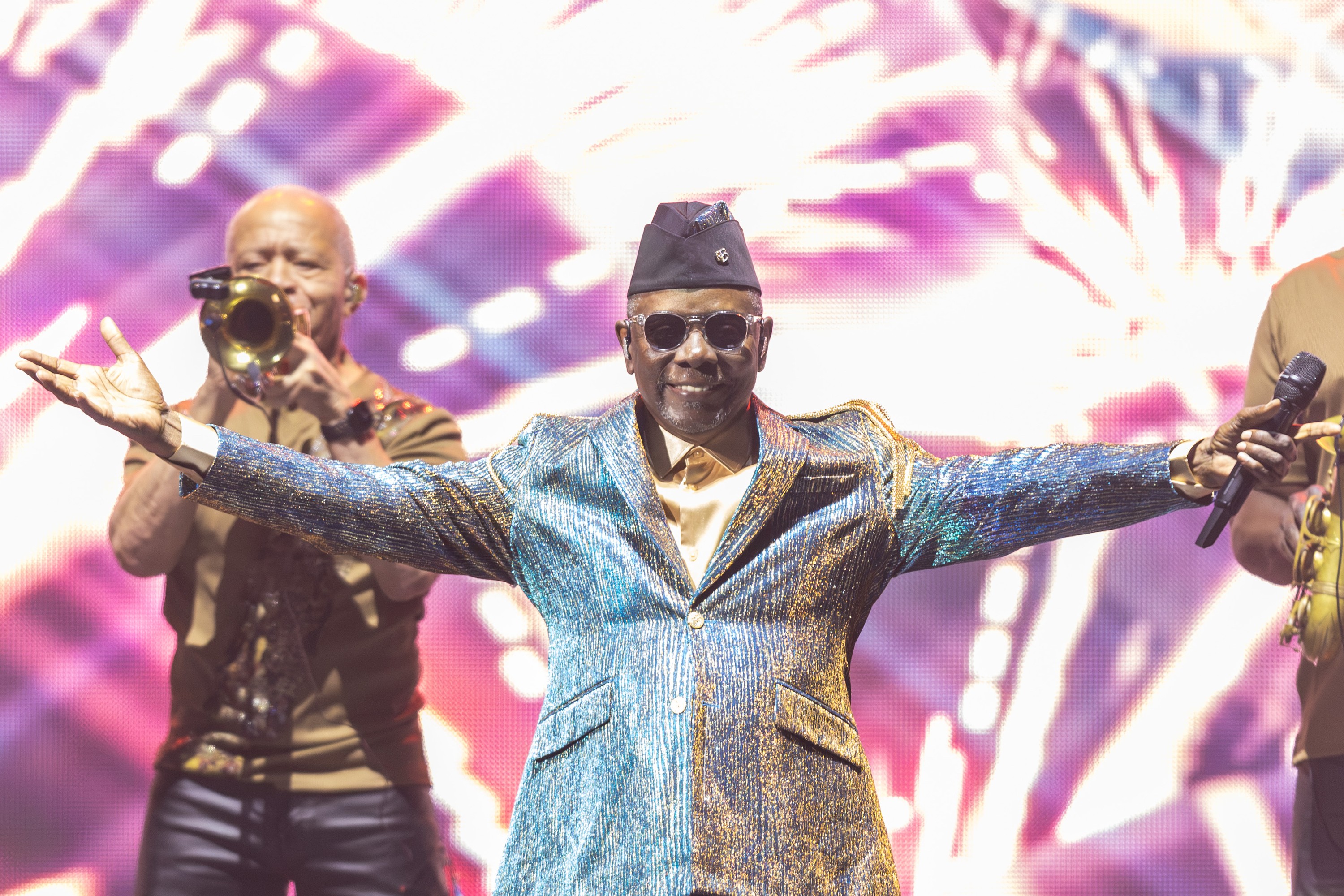 Philip Bailey of Earth, Wind & Fire gestures to the crowd during a concert