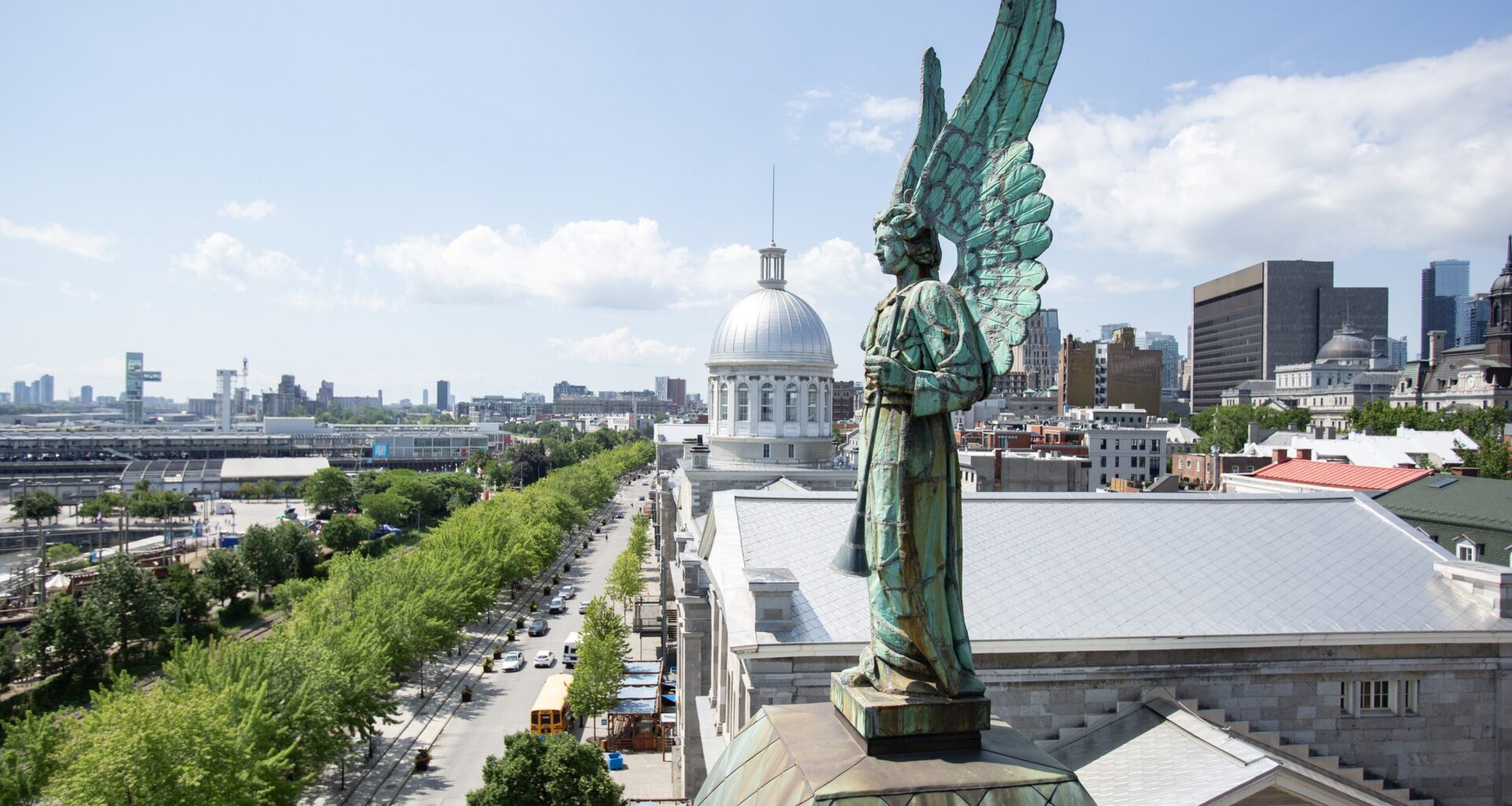 A copper angel statue that has turned green is seen on a rooftop overlooking Old Montreal.