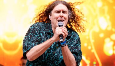 "Weird Al" Yankovic performing with a golden backdrop.