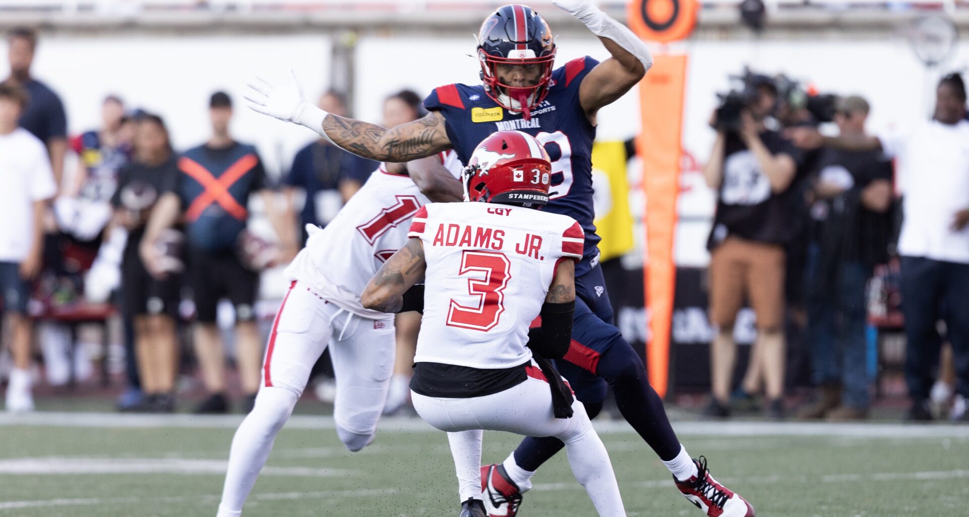 Alouettes defensive-lineman David Perales pressures Stampeders quarterback Vernon Adams Jr.
