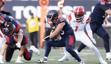 Alouettes quarterback Davis Alexander holds on to the football as he tries to escape pressure.