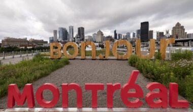 Large cutout signs read BONJOUR MONTREAL, with the city skyline in the background under cloudy skies.