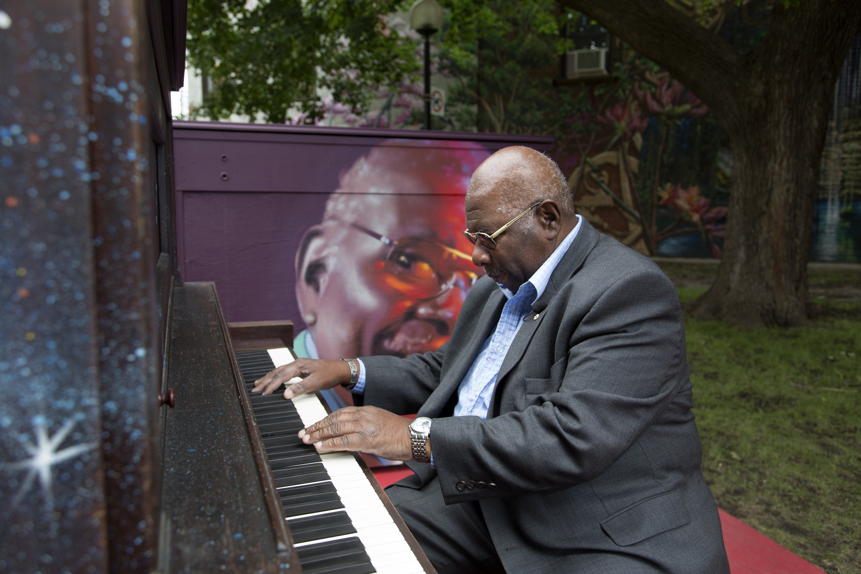 Oliver Jones plays piano in a park