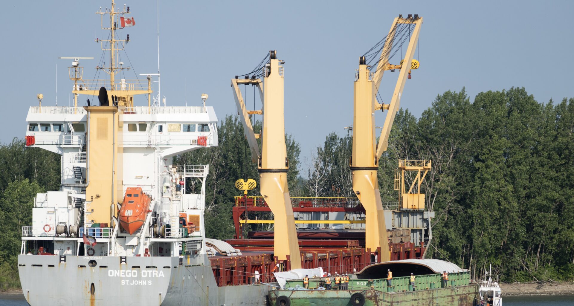 Crews work to free a grounded cargo ship.