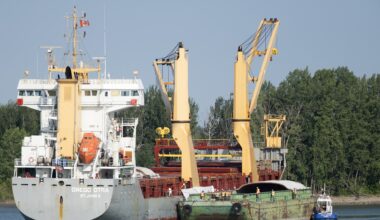 Crews work to free a grounded cargo ship.