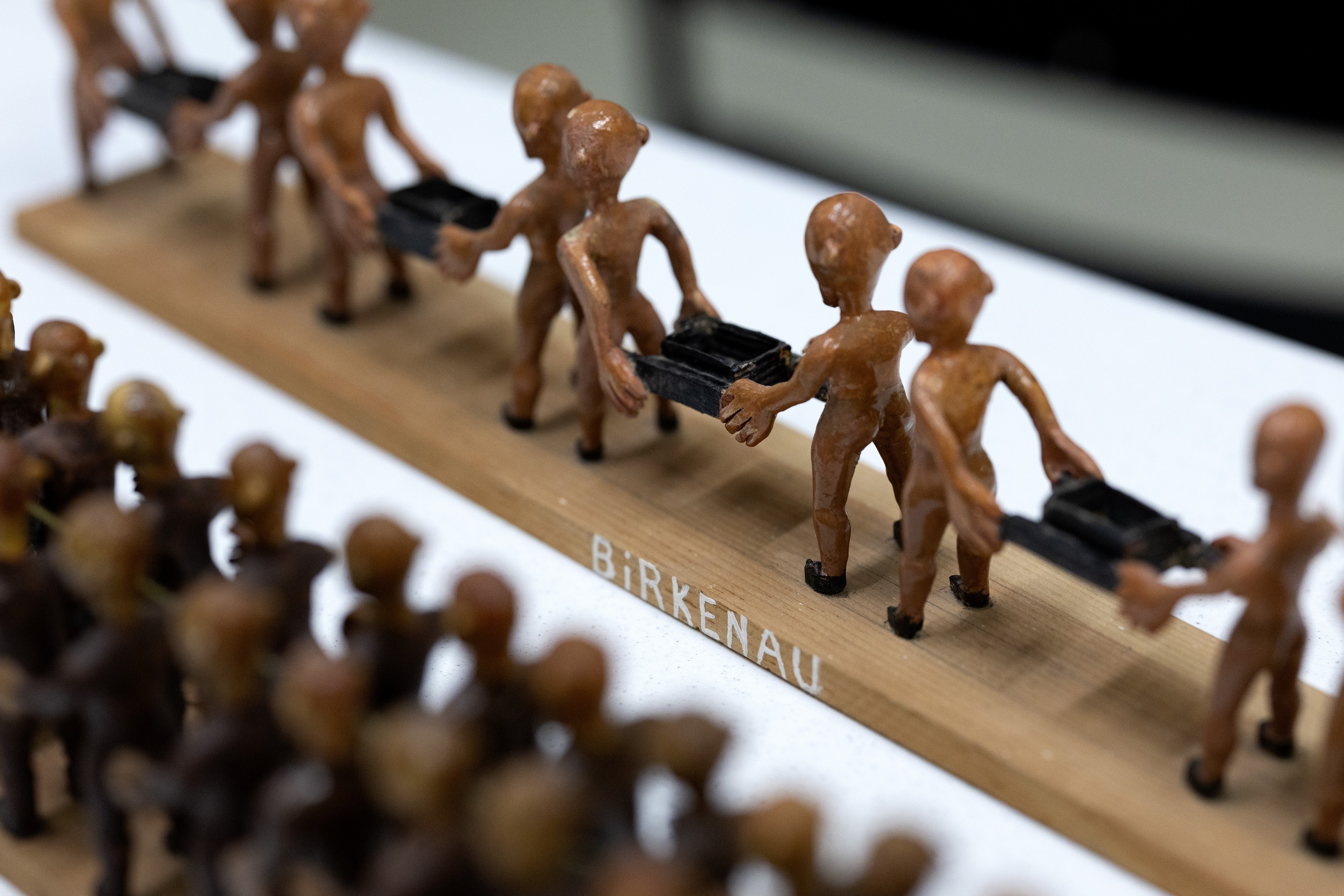 Wood carvings of prisoners at Birkenau. 