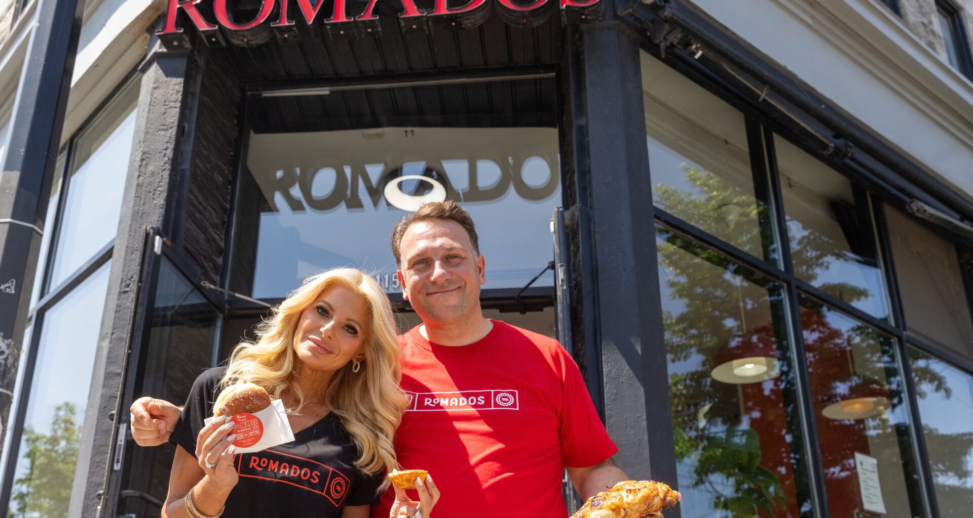A couple show some food from their restaurant.