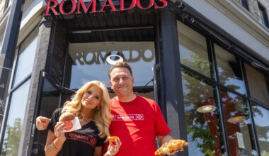 A couple show some food from their restaurant.