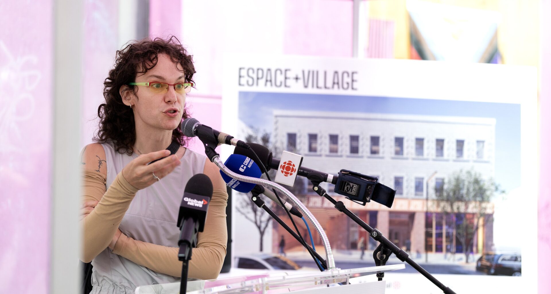 Woman addresses the media.