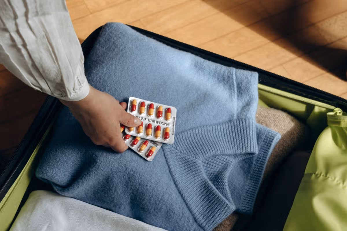 Pills going into a suitcase