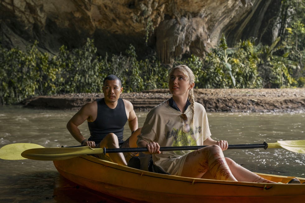 Tayme Thapthimthong, Kathryn Newton, The Devil's Mouth tayme thapthimthong, kathryn newton kayaking through a cave with lush greenery in the devil's mouth movie