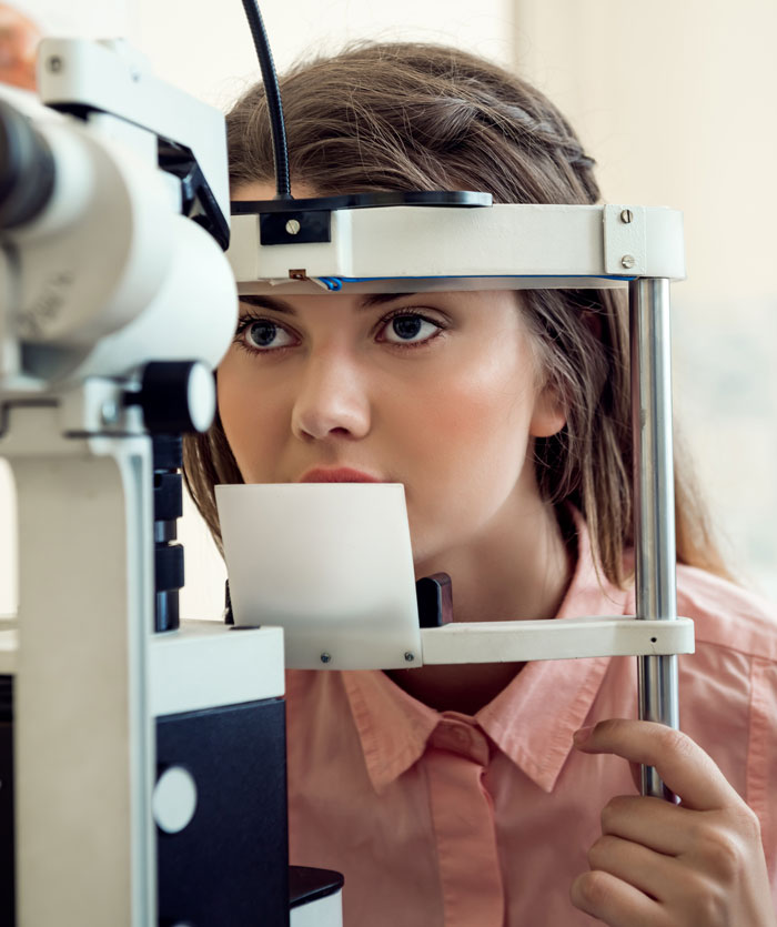 A young female patient having her eyes examined by a doctor, failing to outsmart their doctors.