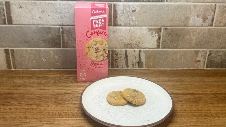 A box of Cybele's Confetti Cookies with two cookies on a plate