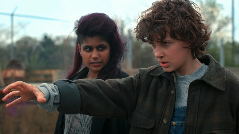 Linnea Berthelsen's Kali watches as Millie Bobbie Brown's Eleven holds her hand out in Stranger Things