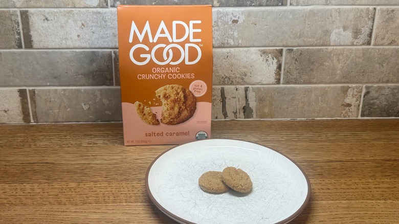 A box of Made Good Salted Caramel Cookies with two cookies on a plate