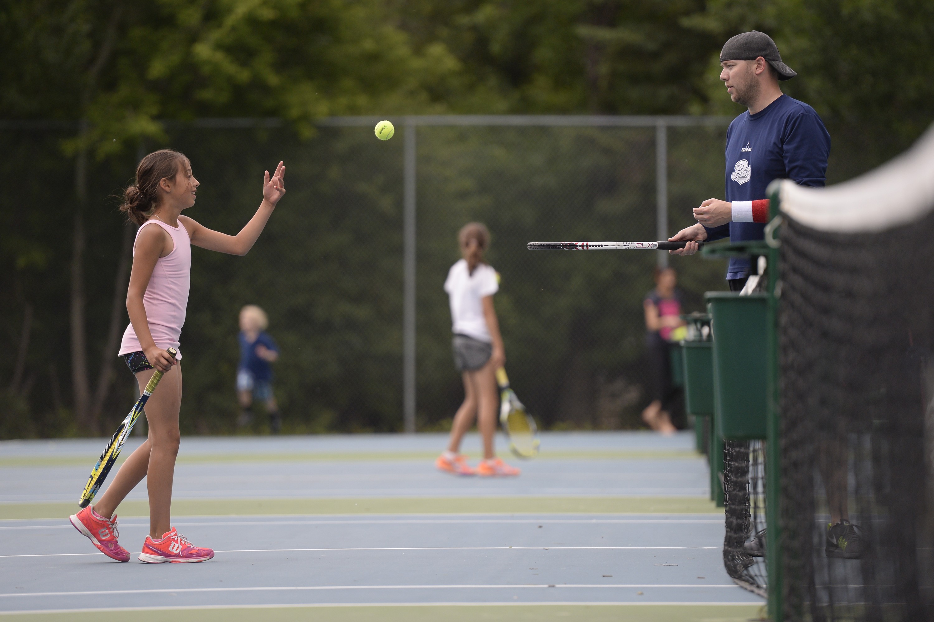 Teah Chavez tosses a ball to Nathan Morrison at the Lakeshore Tennis Club in Regina on Sunday June 21, 2015.