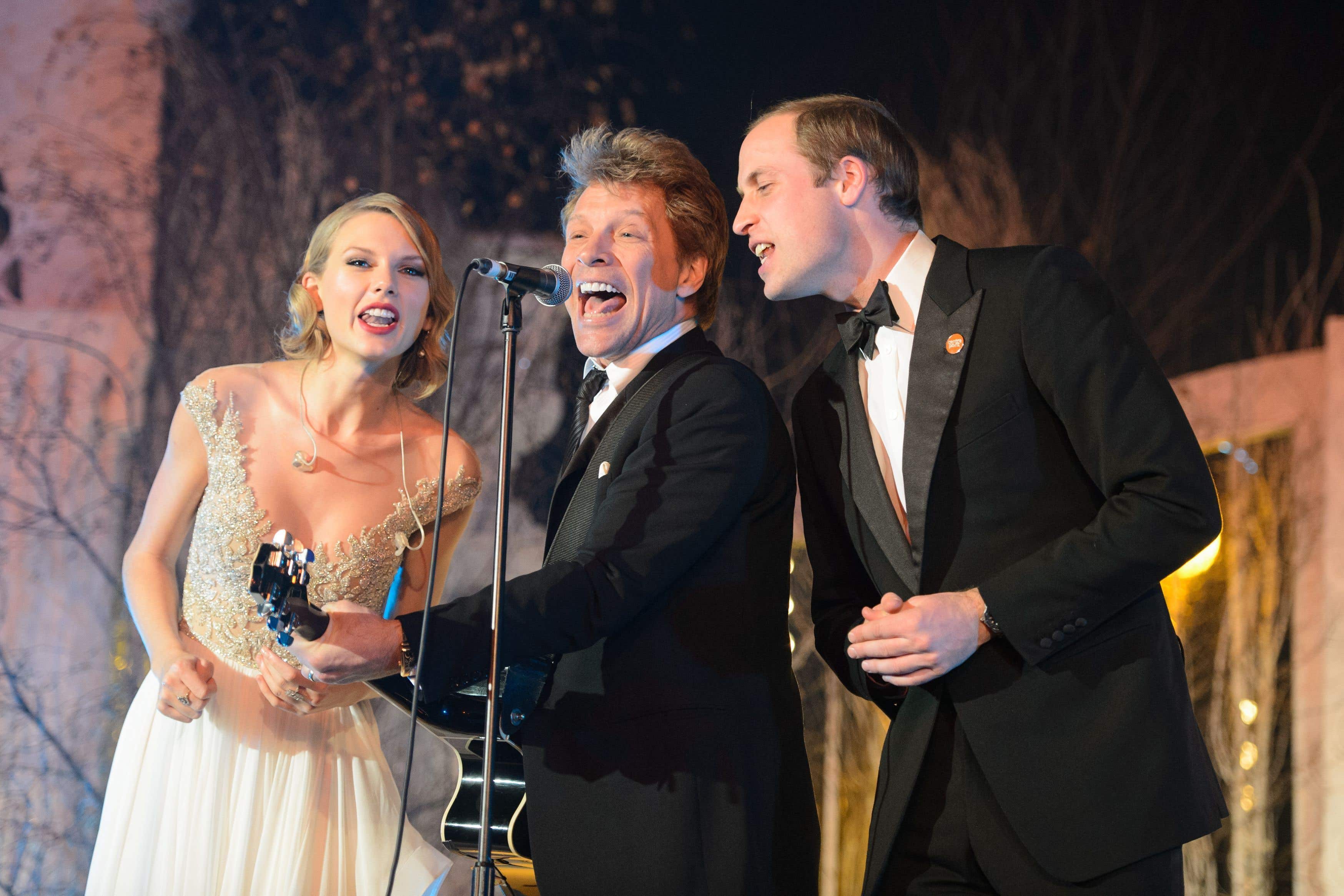 Prince William (right) sings with Taylor Swift (left) and Jon Bon Jovi at the Centrepoint Gala Dinner at Kensington Palace, London in 2013