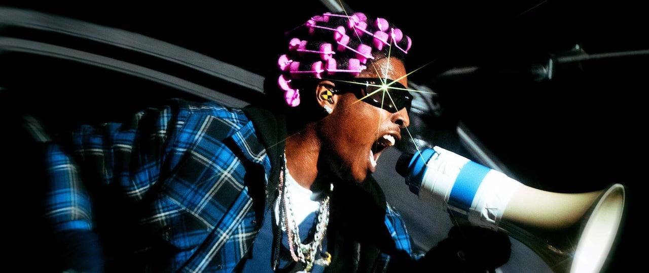 A man screams into a megaphone.