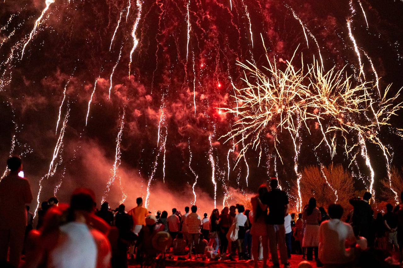 People take in a Victoria Day fireworks show at Woodbine Beach in Toronto on Monday, May 18, 2026. THE CANADIAN PRESS/Arlyn McAdorey