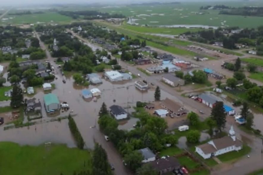 Drone view of floodwater surrounding homes, businesses and roads throughout the village of Norquay, Saskatchewan after heavy rainfall.
